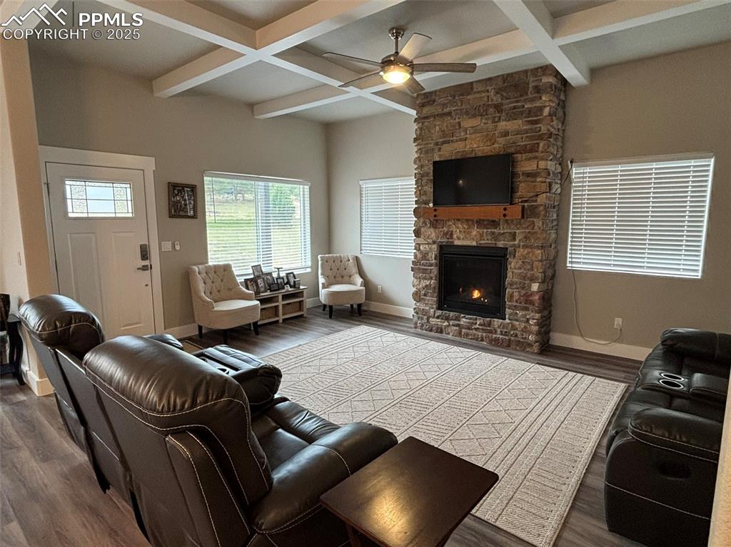 Image 6 of 29: Living area featuring beam ceiling, coffered ceiling, dark wood-style floor