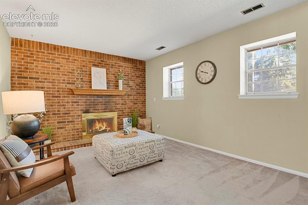 Image 15 of 28: Cozy family room with fireplace.