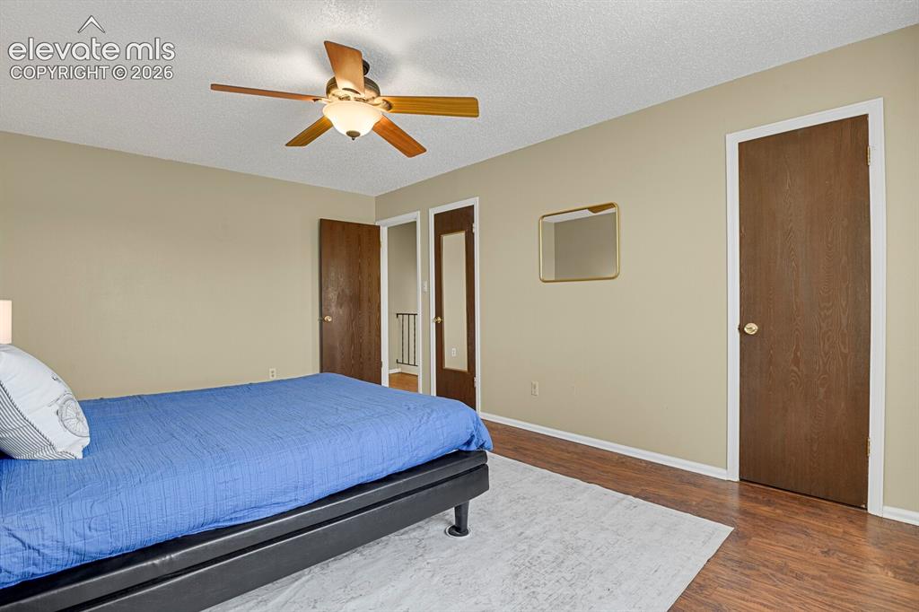 Image 17 of 28: Bedroom featuring wood-finish flooring, a ceiling fan with integrated light