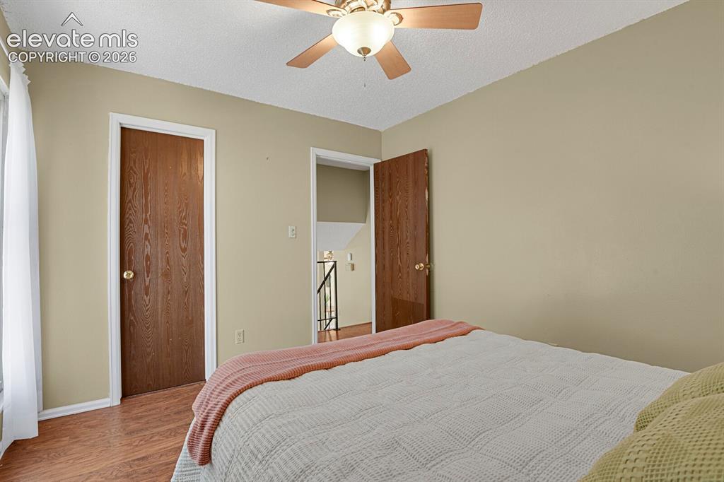 Image 20 of 28: Interior room featuring wood-finish flooring, a ceiling fan with light fixt