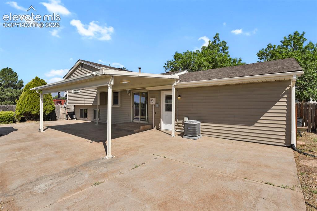 Image 24 of 28: Concrete patio with a covered outdoor area