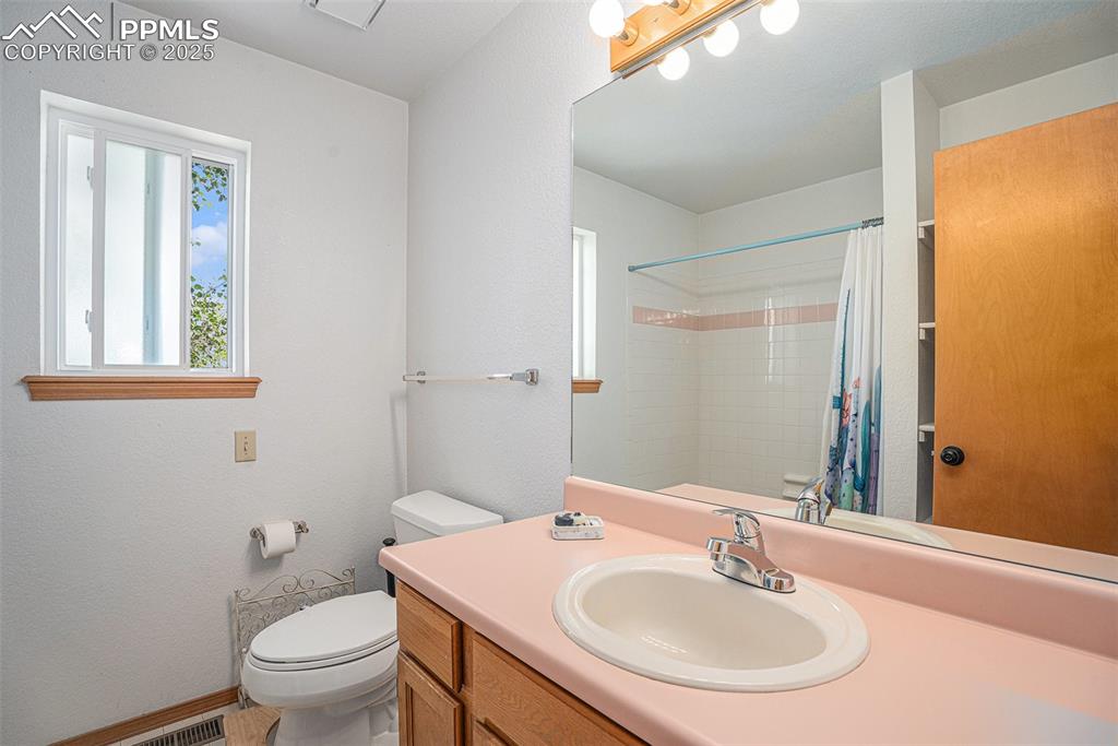 Image 14 of 27: Bathroom with vanity and a shower with curtain