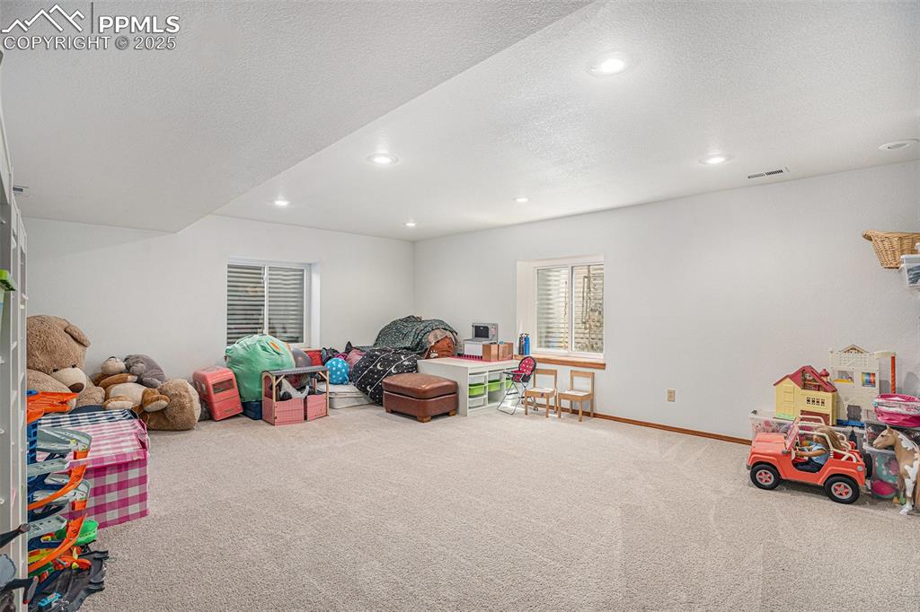 Image 16 of 27: Rec room with carpet flooring, recessed lighting, and a textured ceiling