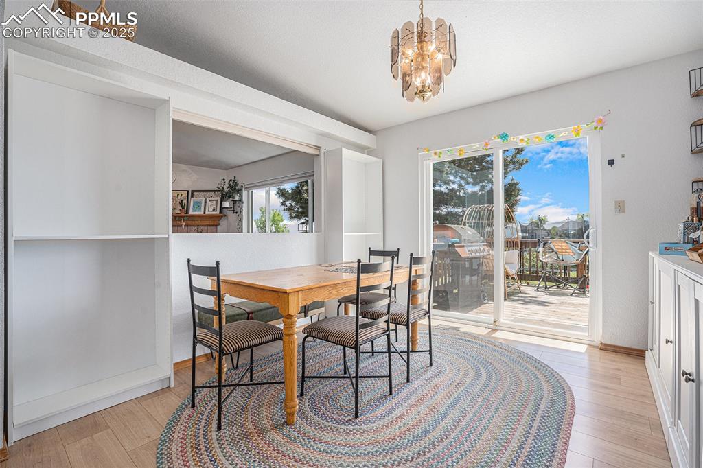 Image 7 of 27: Dining area with a chandelier and light wood-type flooring