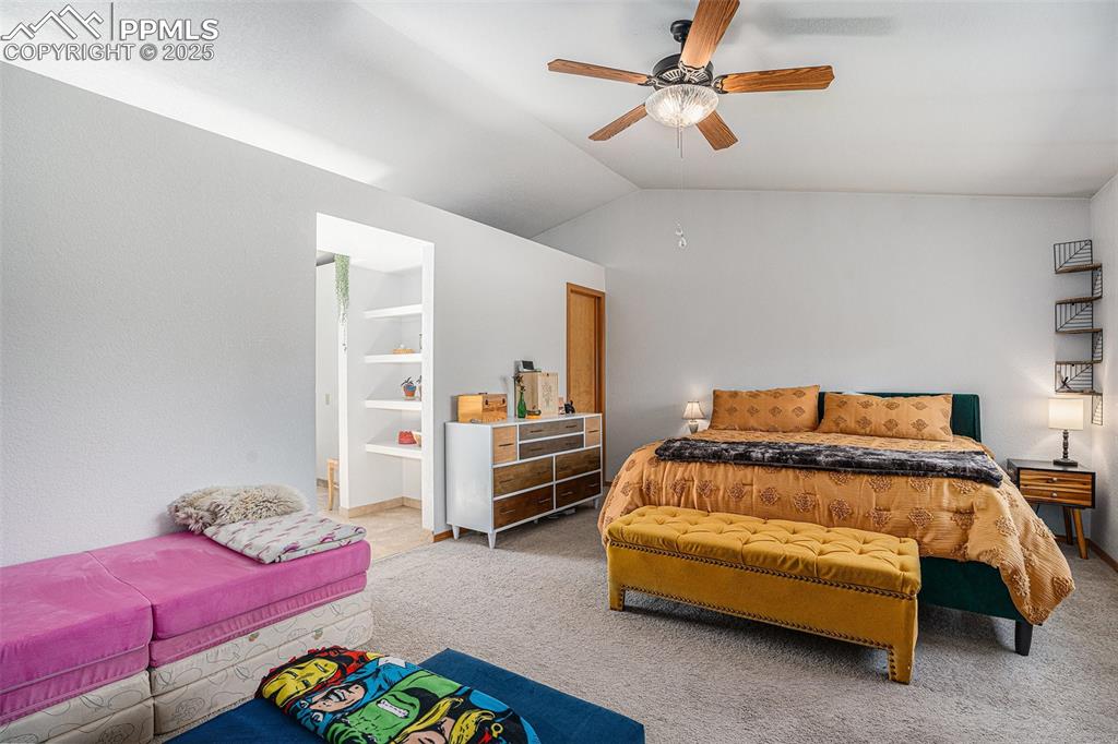 Image 8 of 27: Bedroom featuring carpet floors, vaulted ceiling, and a ceiling fan