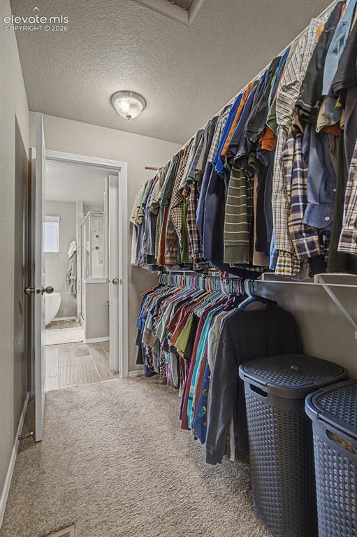 Image 22 of 40: Primary closet connected to bathroom and Laundry