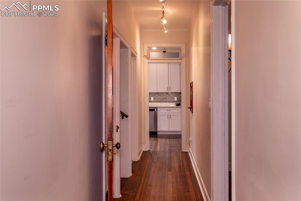 Image 16 of 49: Corridor to access kitchen, upper and lower stairs, bathroom, living/dingin