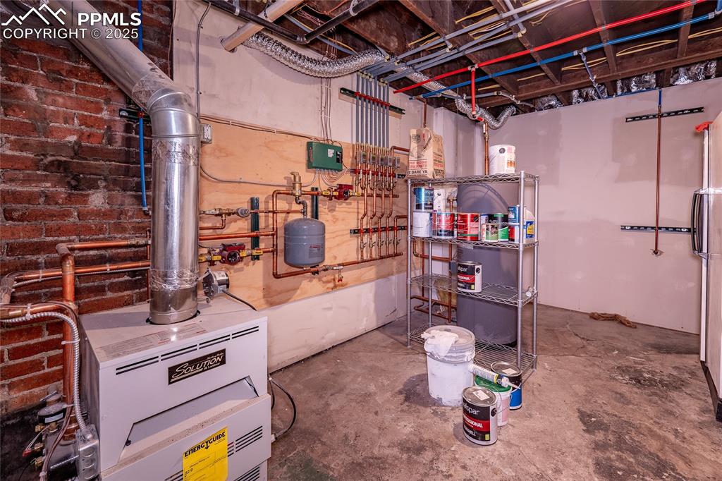 Image 32 of 49: Utility room with a heating unit