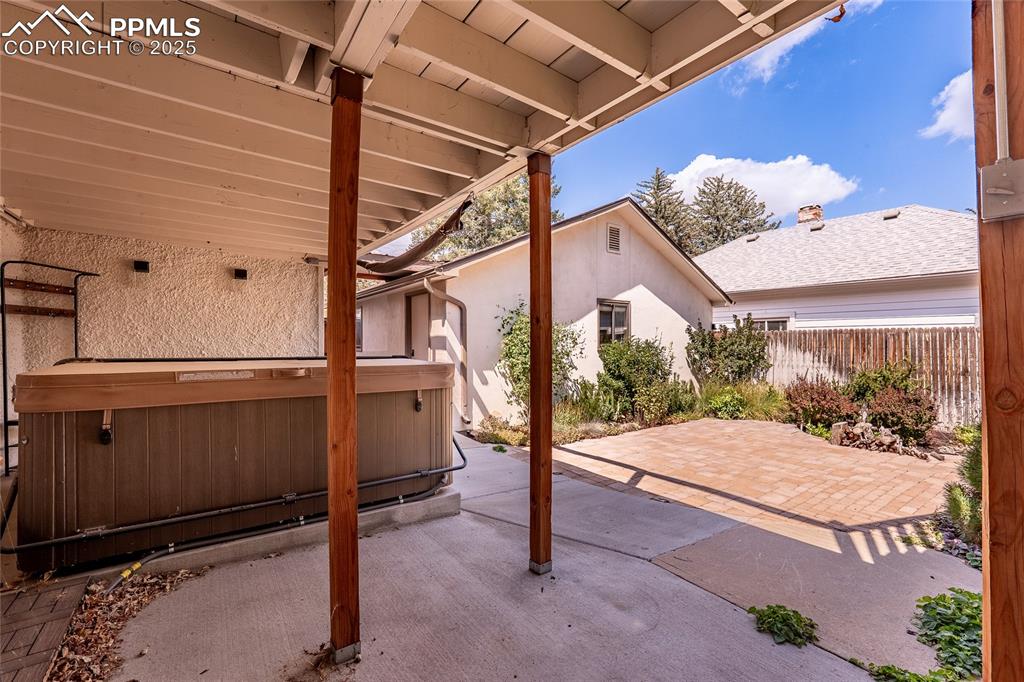 Image 37 of 49: View of patio / terrace featuring a hot tub