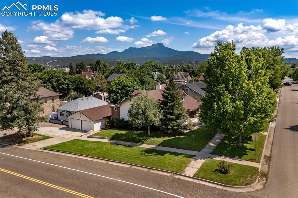 Image 44 of 49: Aerial perspective of the house and corner lot.