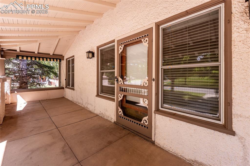 Image 6 of 49: Property entrance with stucco siding