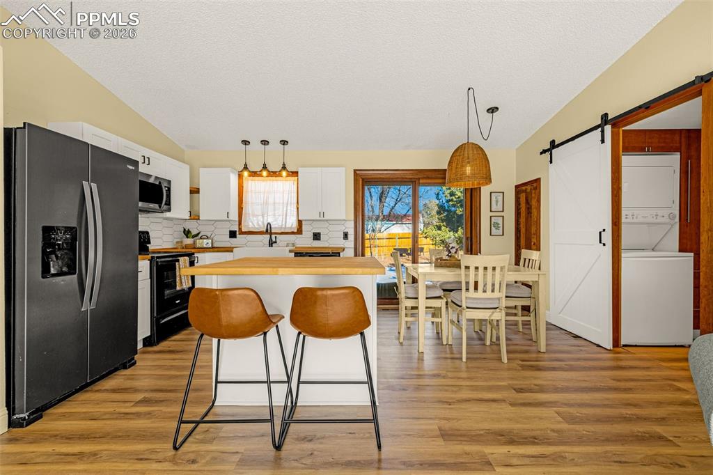 Image 3 of 20: Open Kitchen showing Laundry area