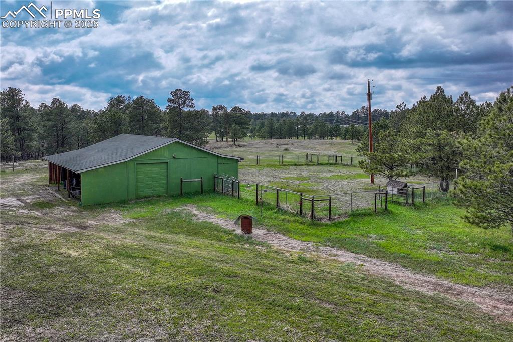Image 47 of 50: Covered parking plus barn and fenced in area.