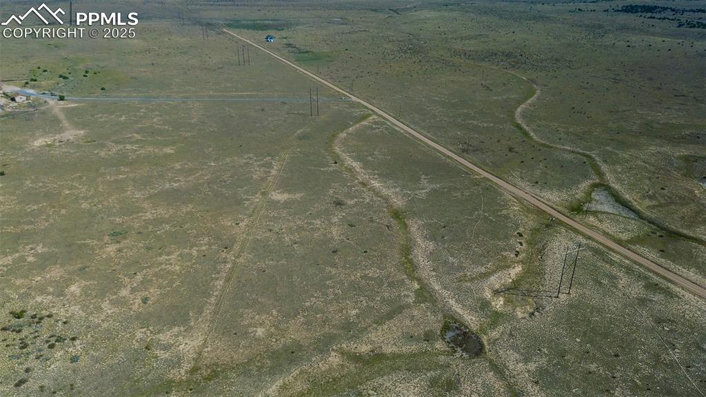 Image 14 of 17: Aerial view of property and surrounding area featuring rural landscape