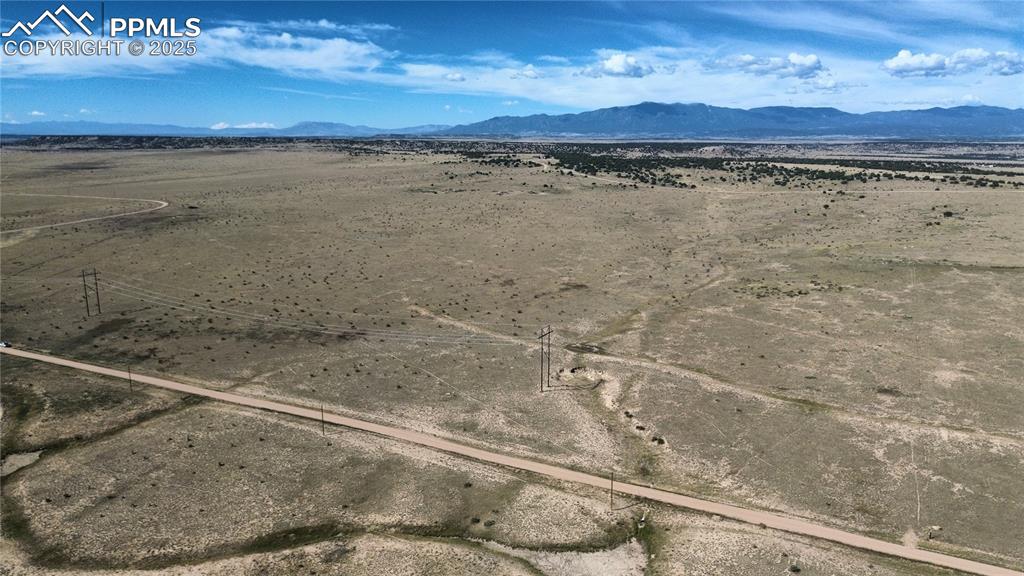 Image 17 of 17: Aerial view of sparsely populated area with a mountain backdrop
