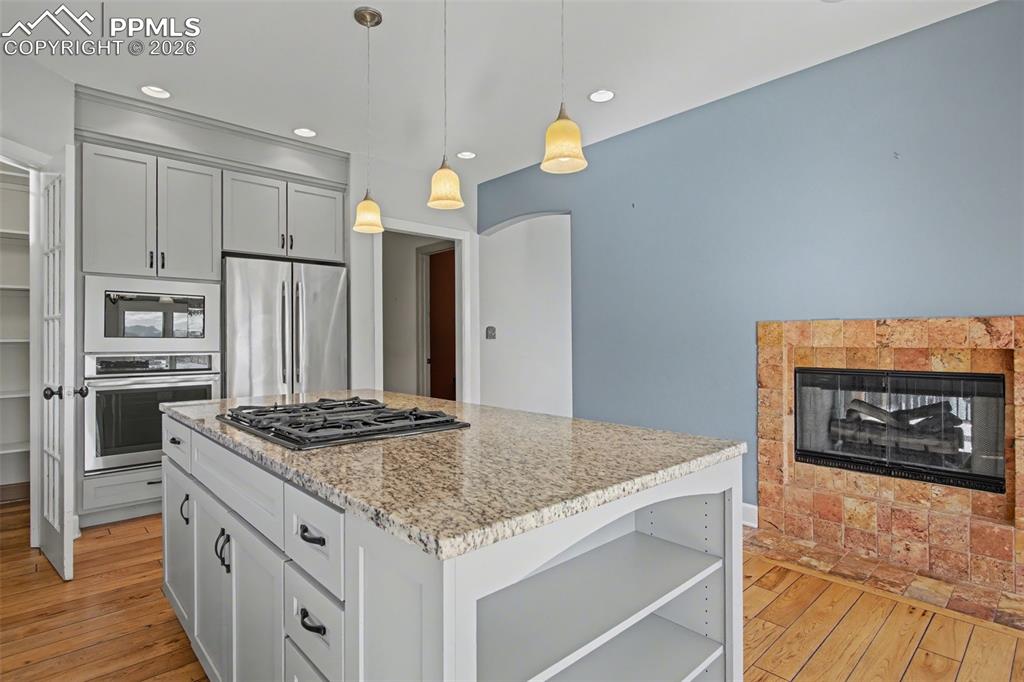 Image 11 of 44: Kitchen with view of pantry and stainless steel appliances. 