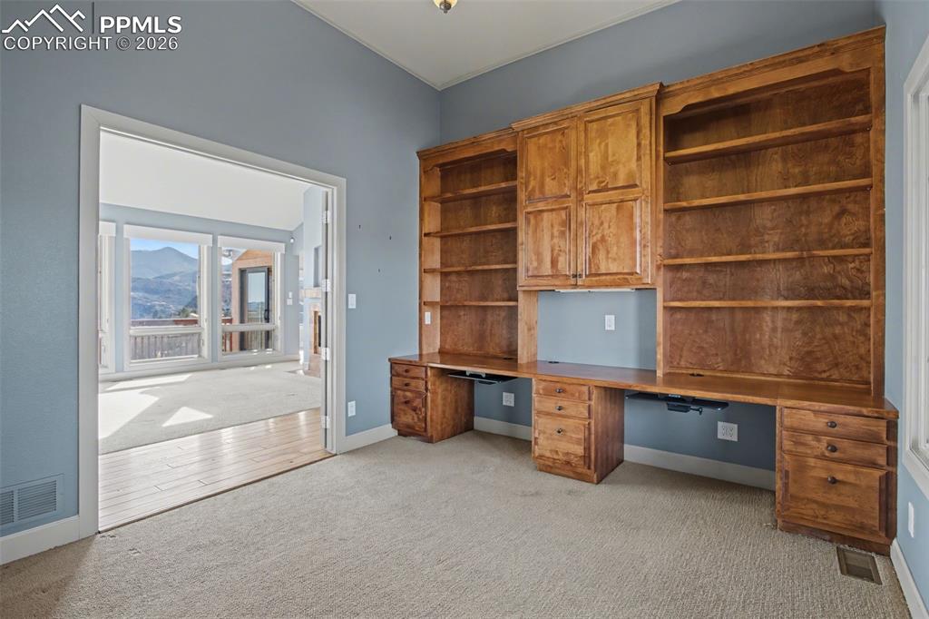 Image 14 of 44: Office with view into living room.