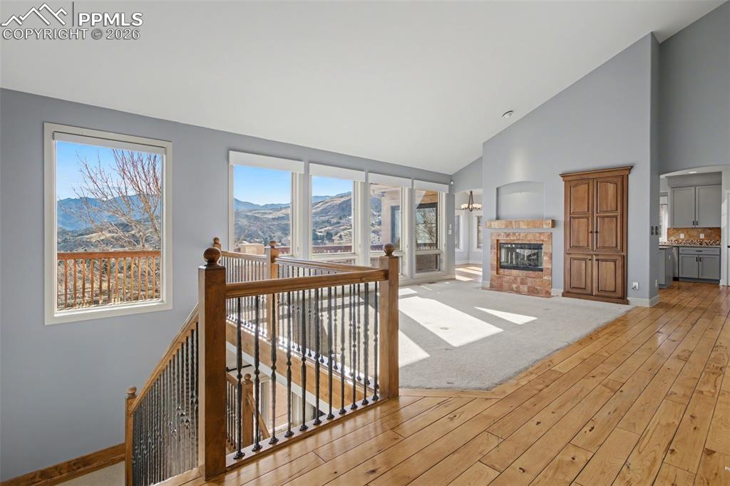 Image 5 of 44: Living room with fireplace, beautiful mountain views and ample natural ligh