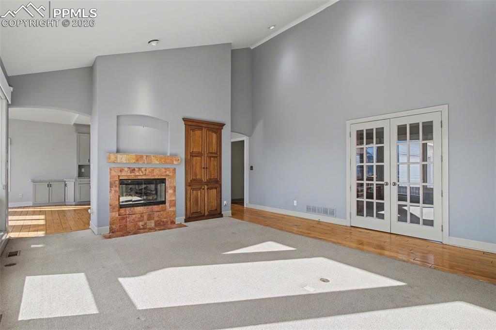 Image 6 of 44: Living room with view of office with double french doors.