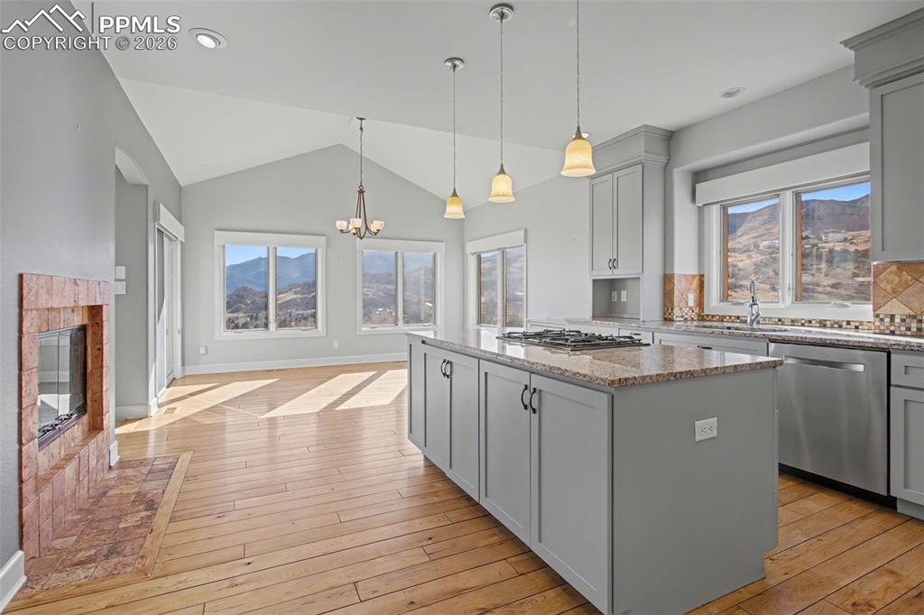 Image 9 of 44: Kitchen with fireplace and island.