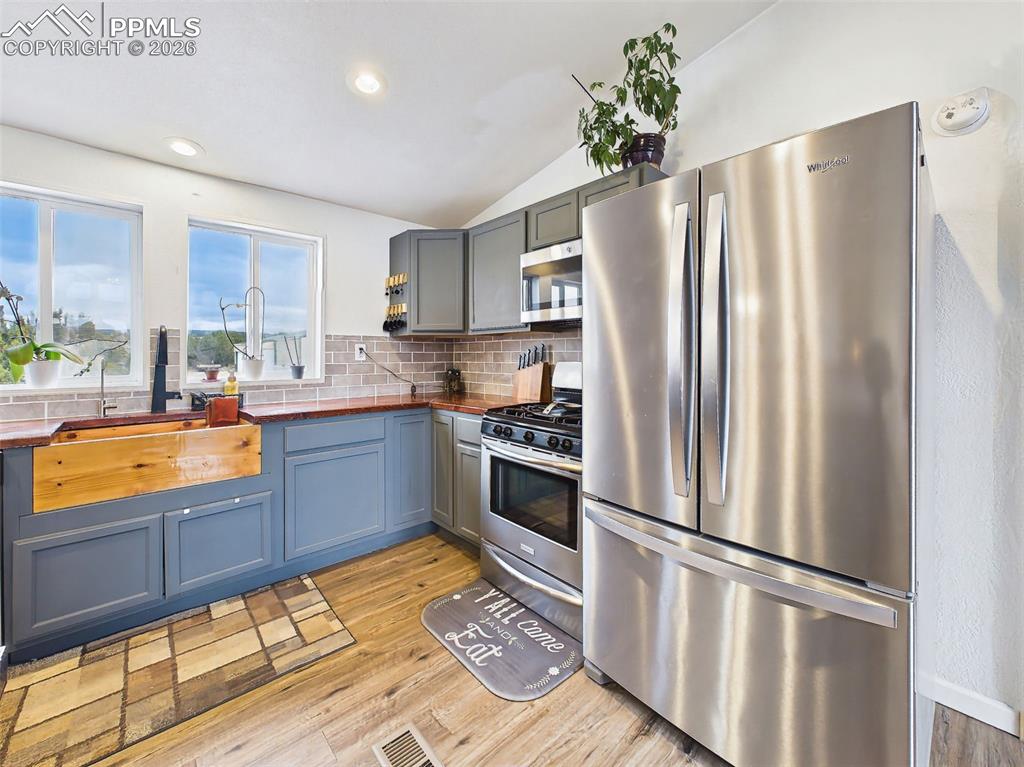 Image 11 of 50: Kitchen – Sink & Appliances – Farmhouse-style wood-accented sink, updated f