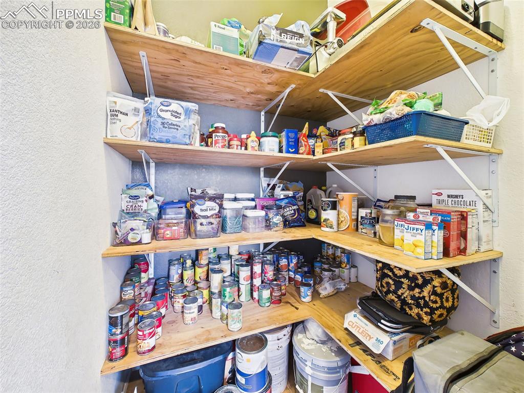 Image 16 of 50: Pantry – Spacious pantry with sturdy built-in shelving offers ample storage