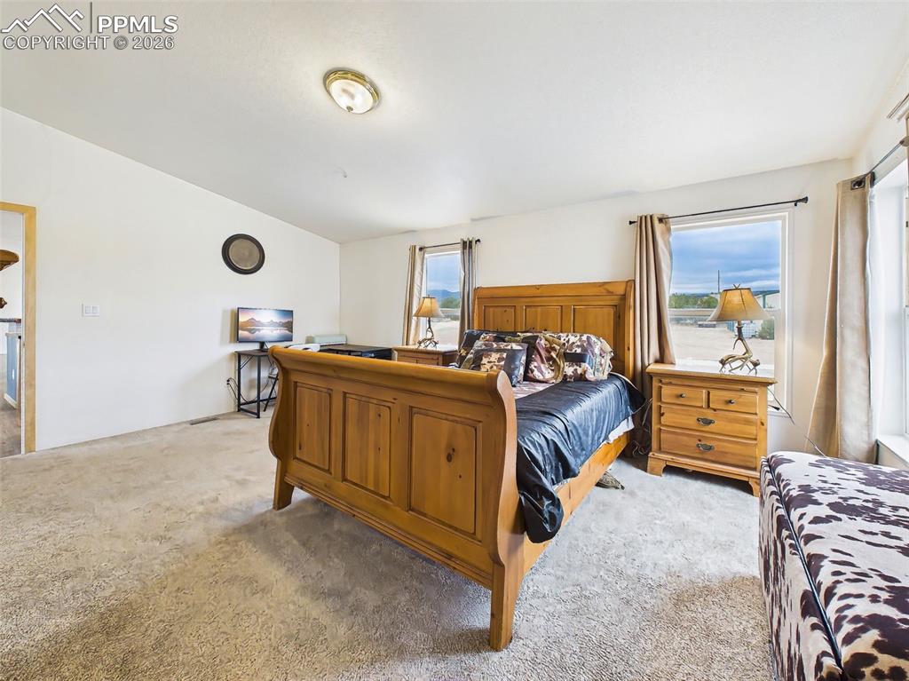 Image 22 of 50: Primary Bedroom – Alternate View – Generous layout allows room for a sittin