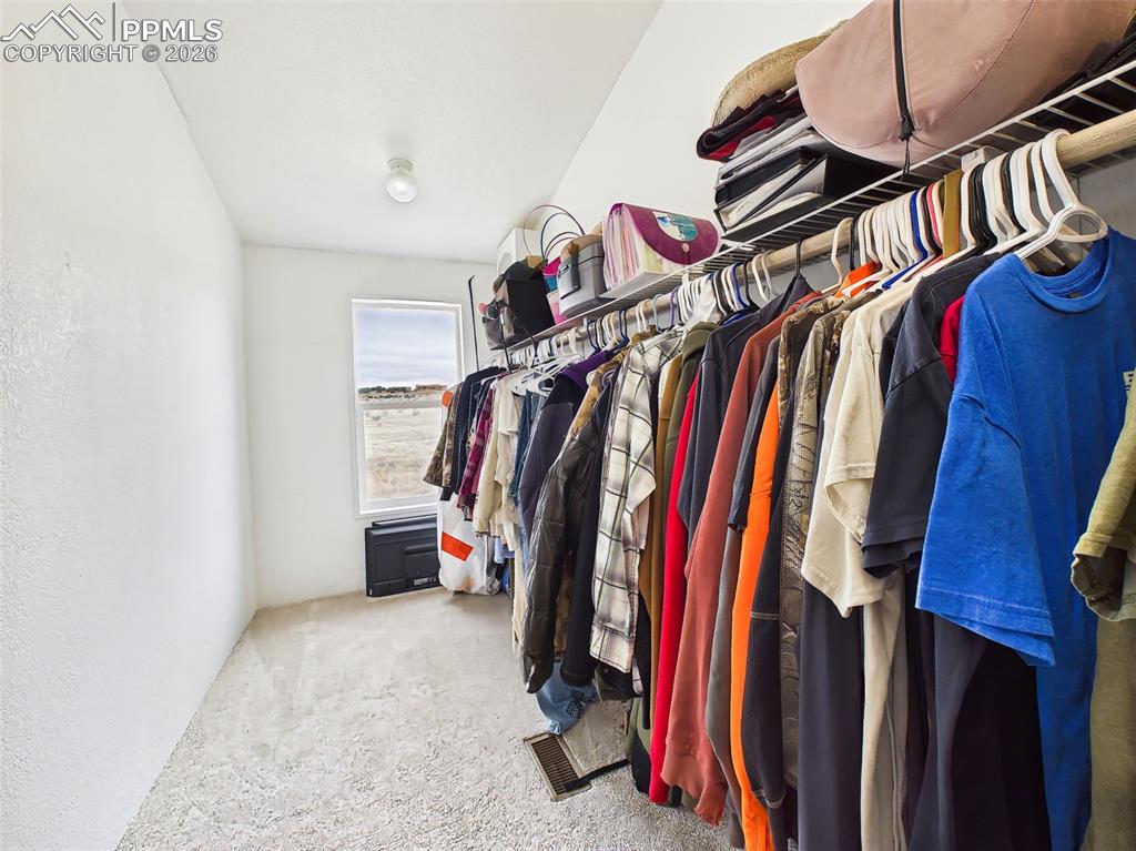 Image 26 of 50: Walk-In Closet (Primary) – Spacious walk-in closet with built-in shelving a