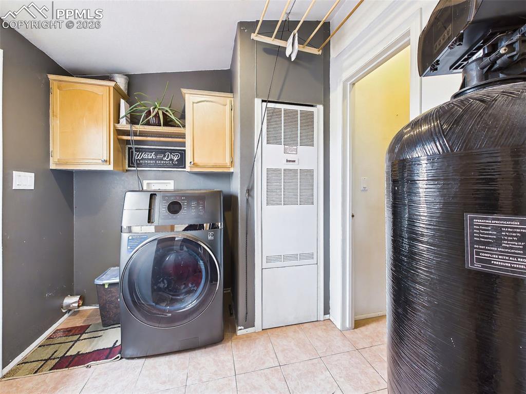Image 31 of 50: Laundry Room – Functional laundry space featuring an energy-efficient combi