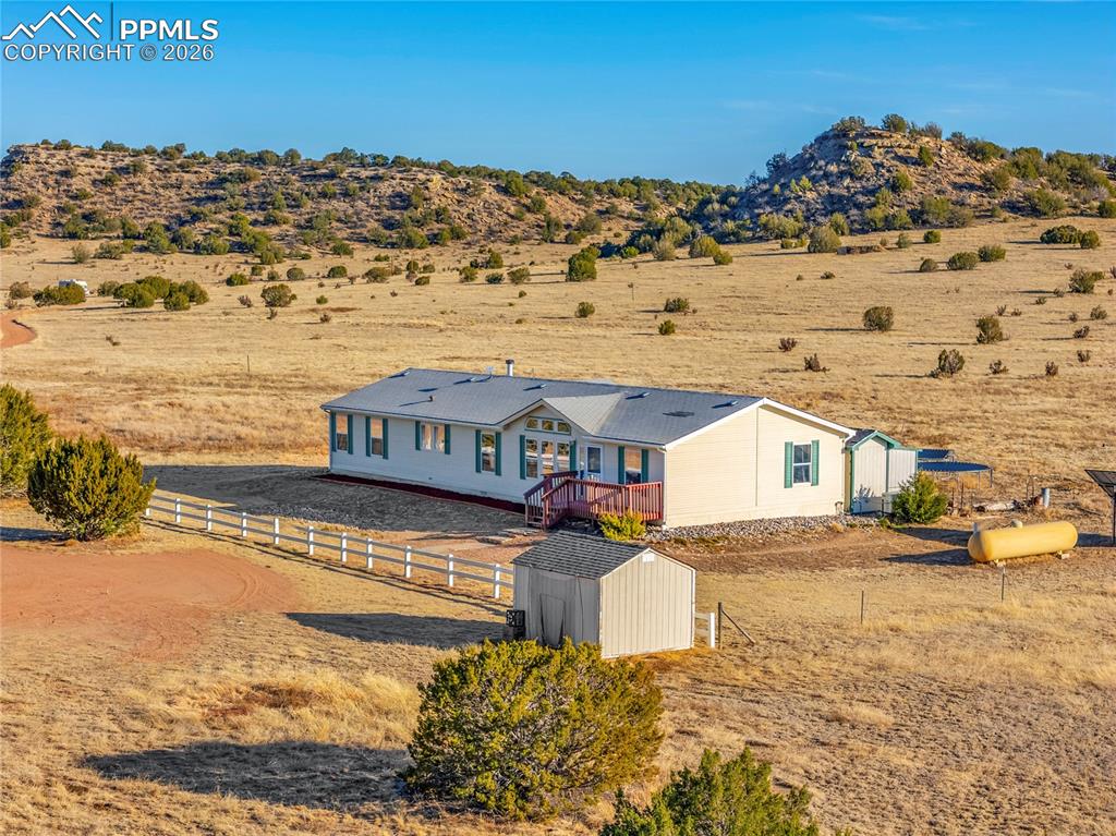 Image 33 of 50: Aerial View – Front Approach & Storage Shed – Overhead view captures the fe