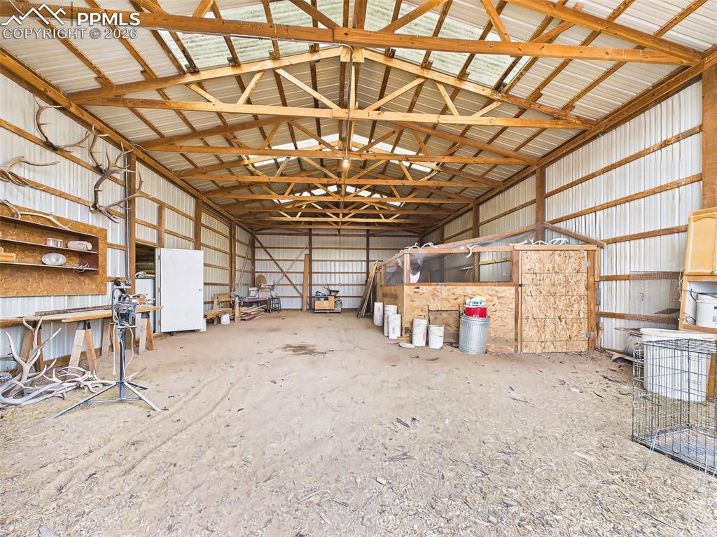 Image 38 of 50: Pole Barn – Interior View – Spacious interior with high ceilings and expose