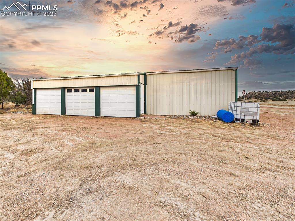 Image 40 of 50: Detached Pole Barn / Garage – Front View – Expansive multi-bay pole barn of
