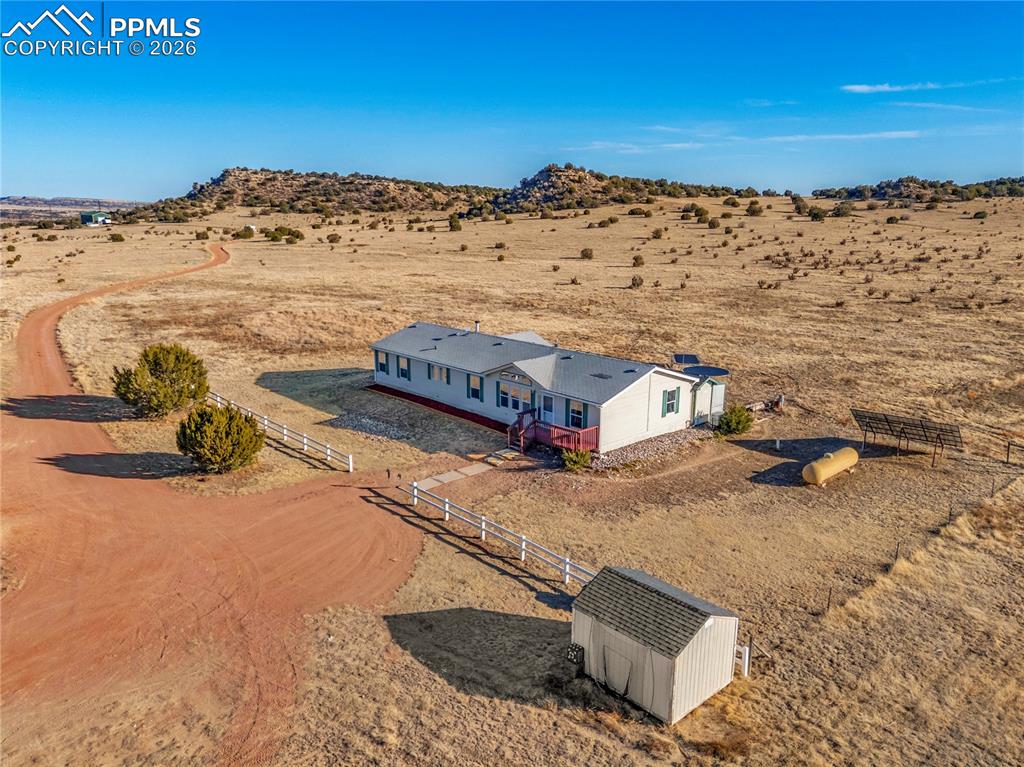 Image 46 of 50: Aerial View – Driveway & Terrain – Sweeping overhead view of the winding ac
