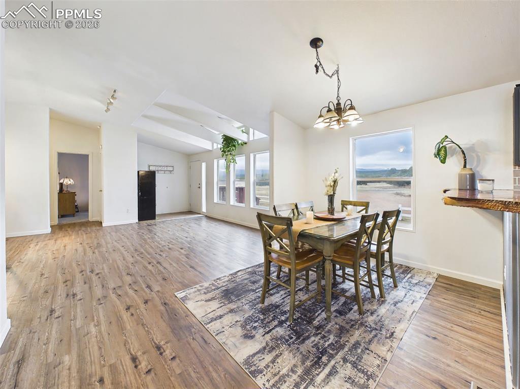 Image 7 of 50: Dining Area – Defined dining space positioned just off the kitchen with lar