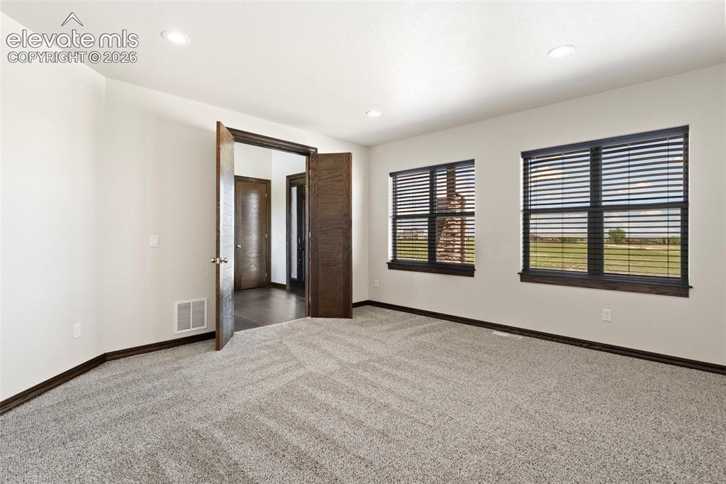 Image 10 of 46: Spacious office featuring light-colored walls, recessed ceiling lighting, a