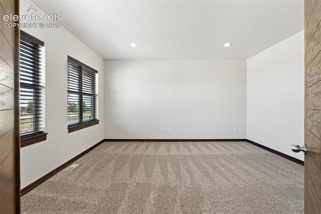 Image 11 of 46: Spacious office featuring neutral carpeting, recessed ceiling lighting, two