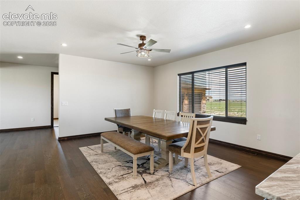 Image 20 of 46: Formal Dining area featuring dark wood-finish flooring, recessed lighting,