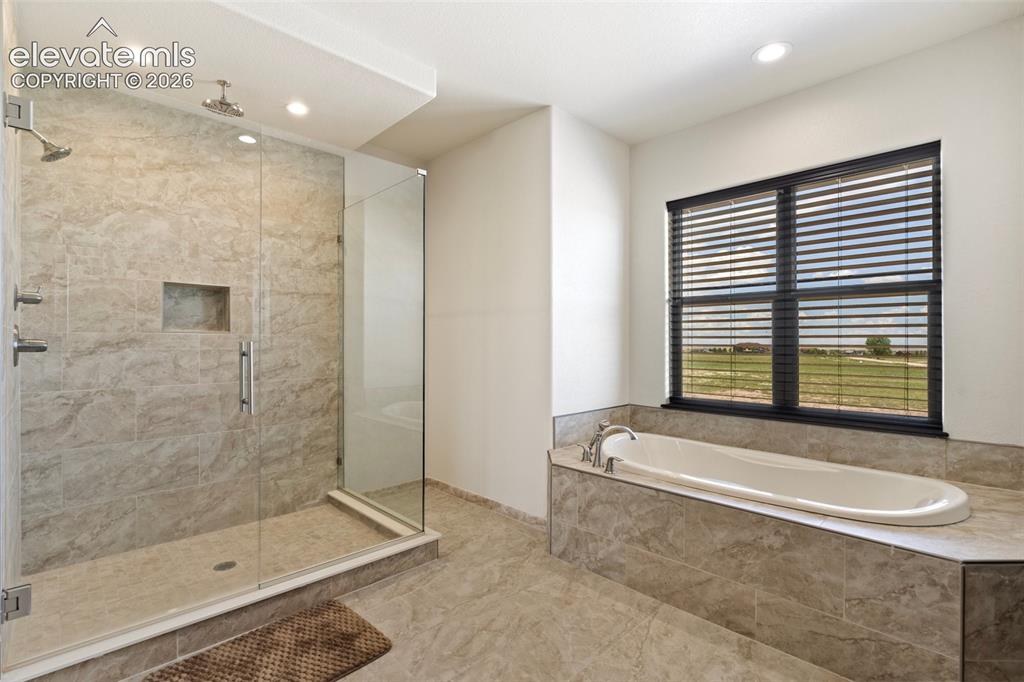 Image 30 of 46: Walk-in shower with full glass enclosure and built-in niche and relaxing so