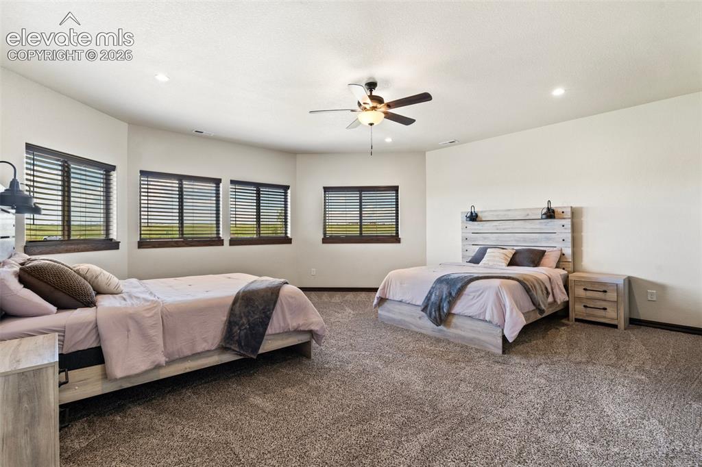 Image 33 of 46: Spacious room featuring multiple windows with dark wood trim, recessed ligh