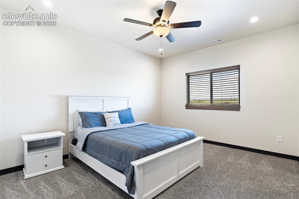 Image 39 of 46: Carpeted room featuring a ceiling fan with integrated lighting, recessed li