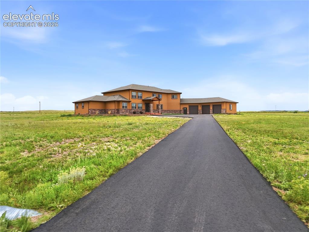 Image 4 of 46: Expansive property featuring a two-story residence with a multi-car attache