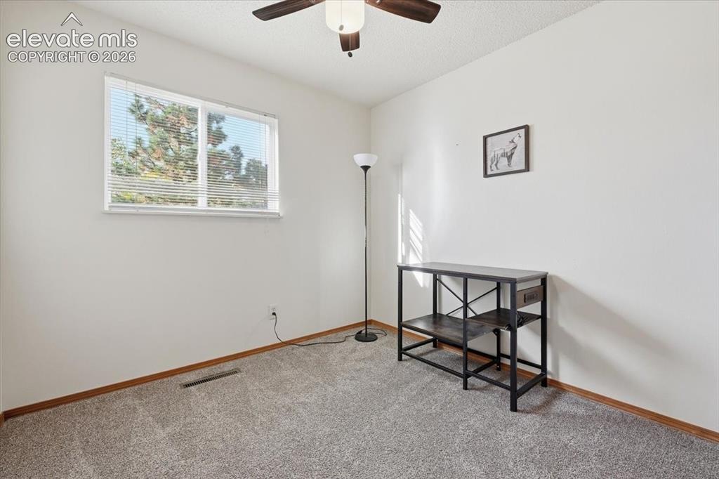 Image 11 of 25: Recessed window with blinds, ceiling fan with integrated lighting, textured