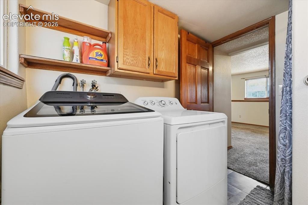 Image 18 of 25: Built-in wood cabinetry, integrated shelving, and tile flooring