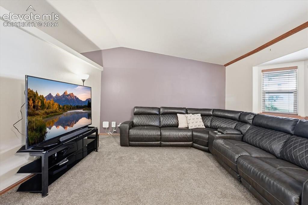 Image 3 of 25: Recessed lighting, wood-finish trim, bay window, and carpeting