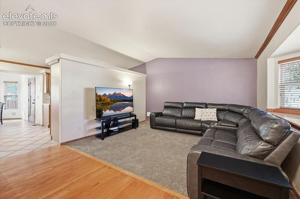 Image 5 of 25: Vaulted ceiling with wood trim accents