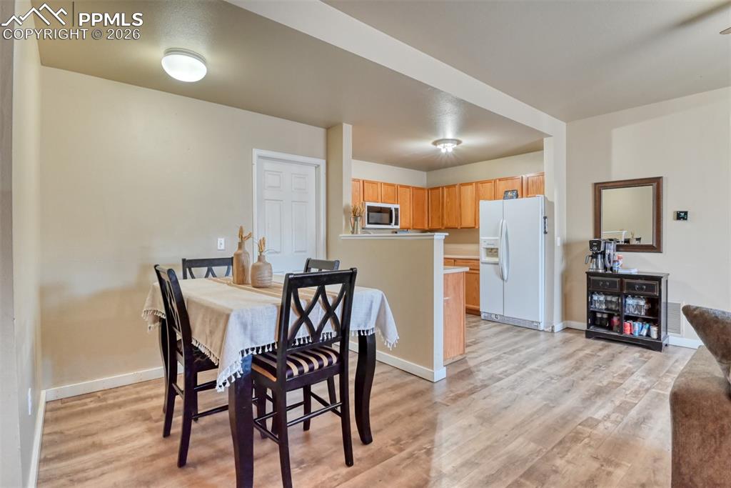 Image 14 of 35: Dining space with light wood-style flooring and baseboards