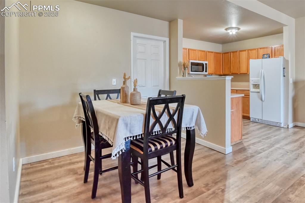 Image 15 of 35: Dining area featuring light wood-type flooring
