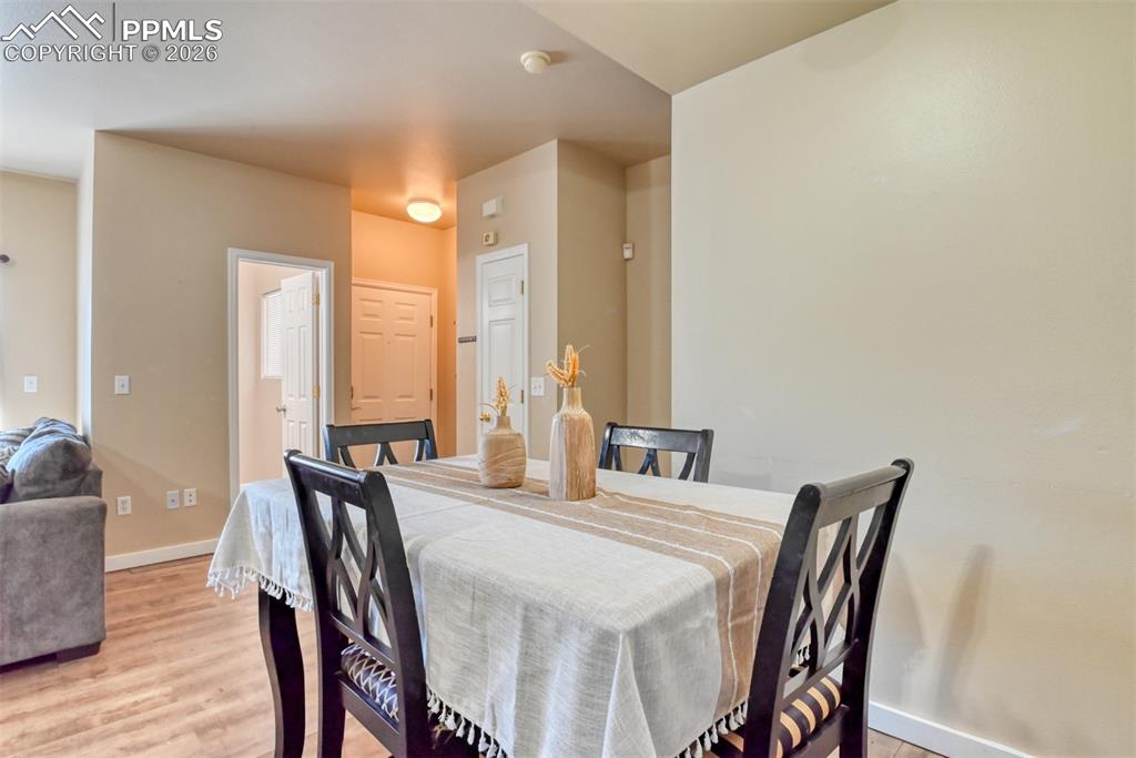 Image 17 of 35: Dining area featuring light wood-type flooring and baseboards