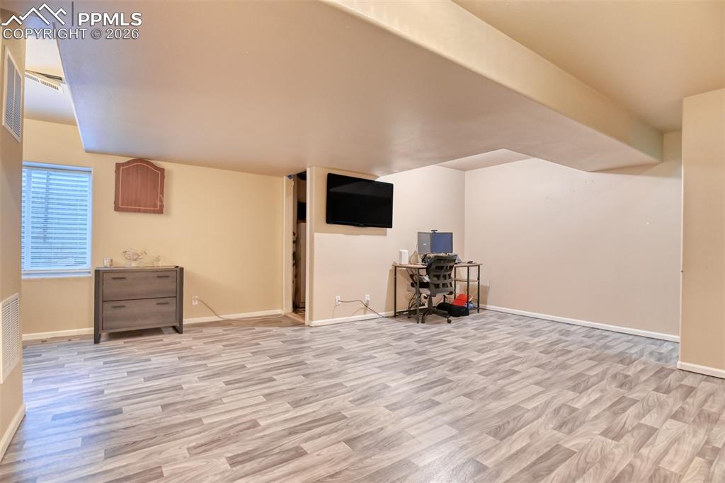 Image 22 of 35: Additional living space with light wood-type flooring and baseboards