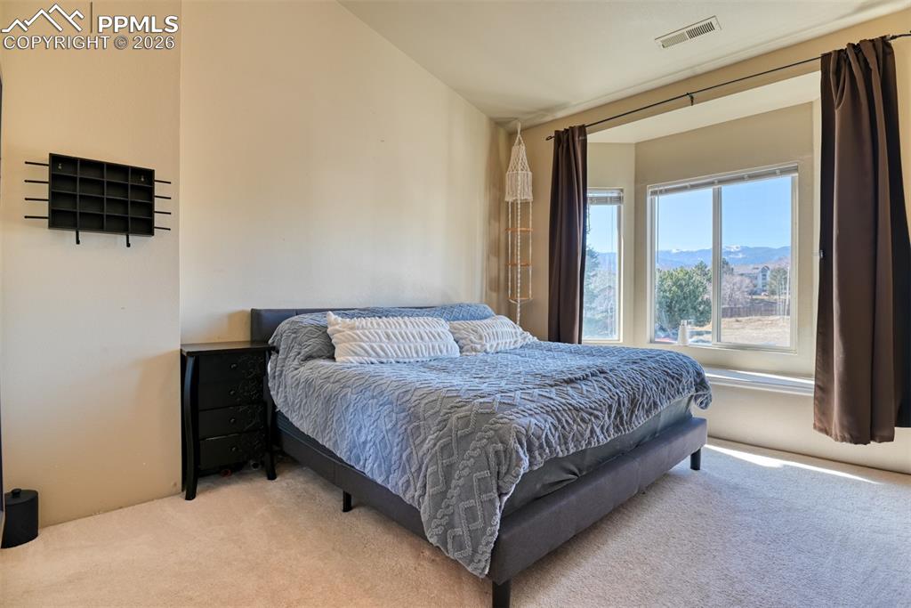 Image 23 of 35: Bedroom featuring light carpet and a mountain view
